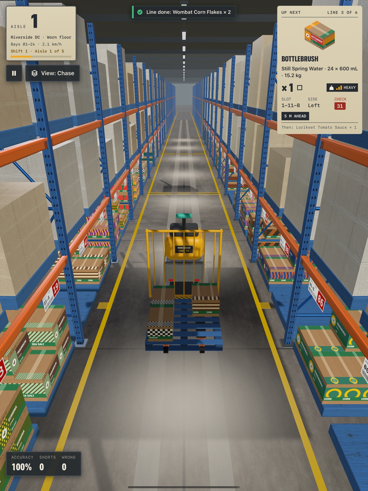 The order picker carrying a part-built pallet down a warehouse aisle lined with racking and labelled pick faces, with an Up next card asking for one case of spring water from slot 1-11-B